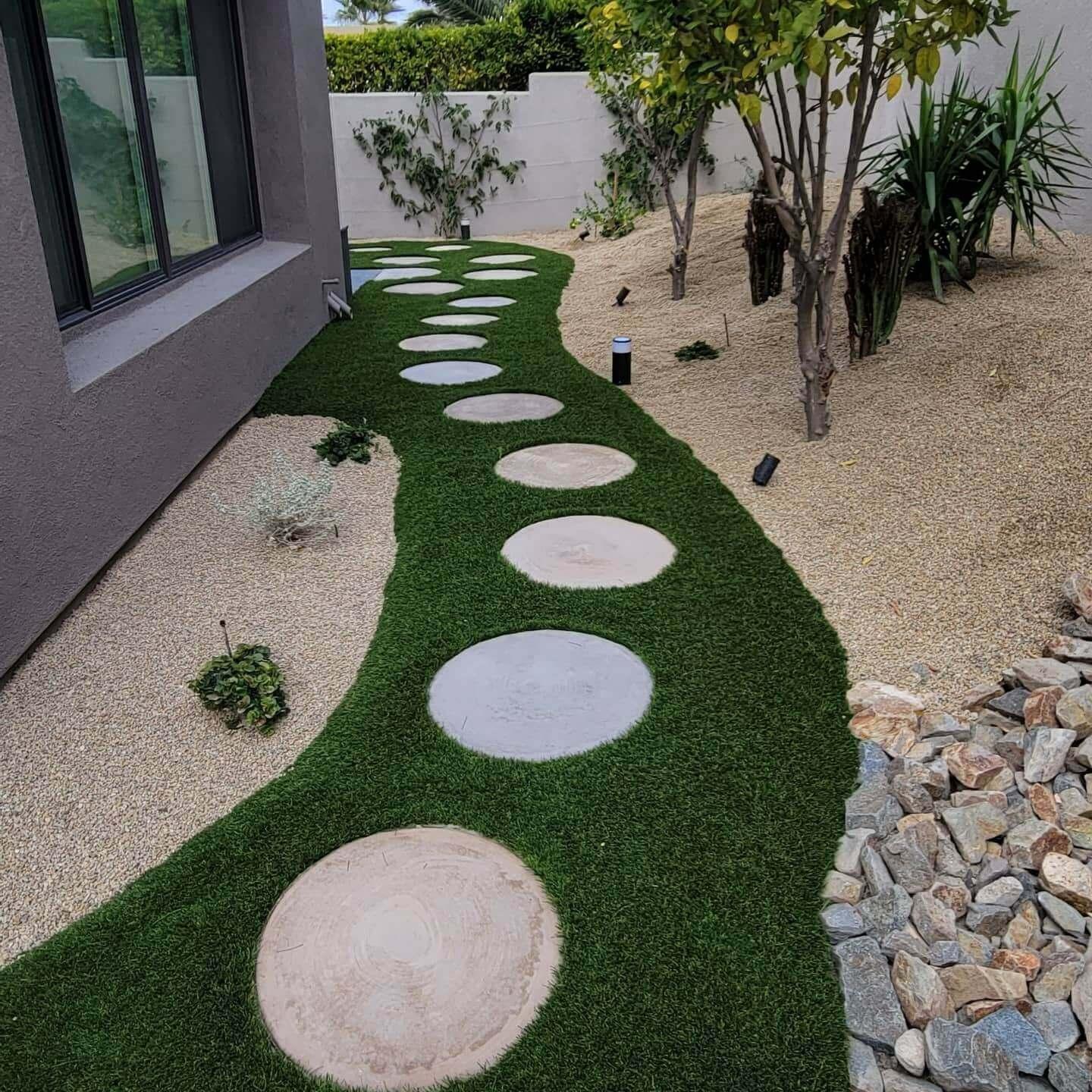 Custom walkway with masonry elements and artificial turf