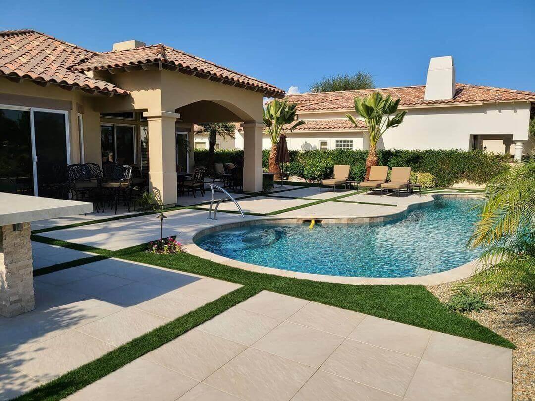 Custom landscape design with a swimming pool and artificial turf